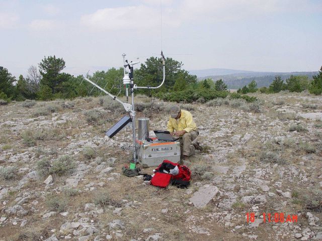 Kip Watson, a BLM RAWS technician sets up a portable weather station during the Jackson Canyon Fire near Casper Wyoming. Picture