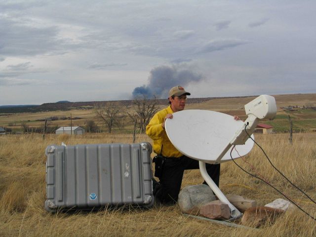 National Weather Service IMET Brent Wachter aiming/positioning the Direcway satellite dish Picture