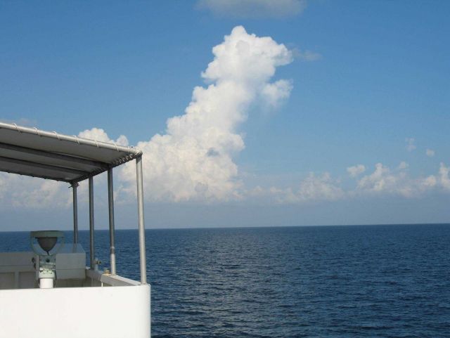 While the TAO buoy streams aft, innocent looking clouds approach Picture