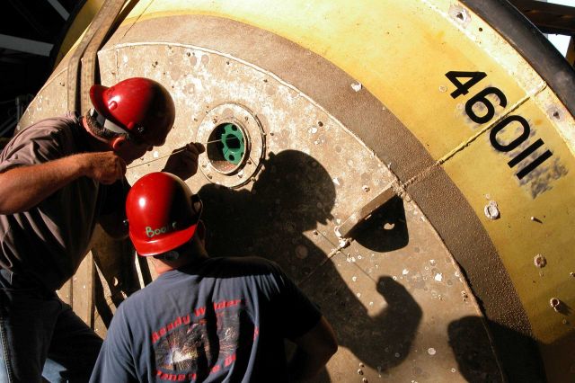 Technicians preparing 3-Meter Buoy for sub-surface instrumentation. Picture