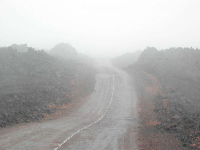 Thick fog often cloaks the lonely road to Hawaii's Mauna Loa Observatory. Picture