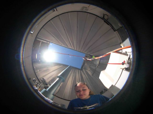 Brooke Walsh measures the ozone layer using Dobson spectrophotometer number 76 shown in this fisheye view inside the Dobson dome at NOAA's Mauna Loa O Picture