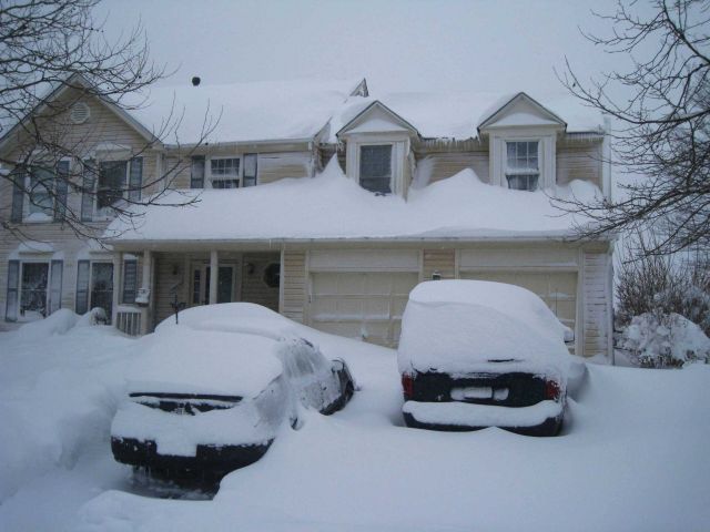 Cars, icicles, and snow covering all. Picture
