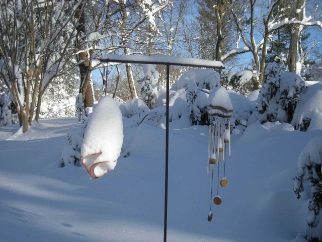 Wind chimes covered by snow. Picture