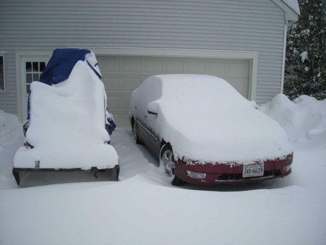 Cars and small tractor following major snowstorm. Picture