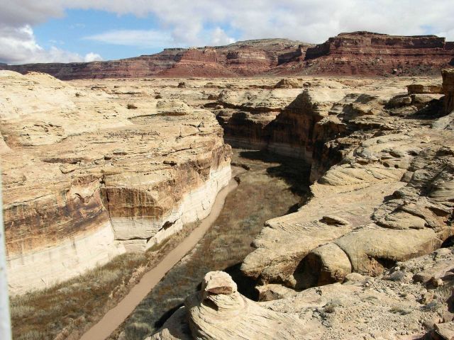 A small stream has cut through the sandstone and overlying red formations of the Colorado Plateau Picture