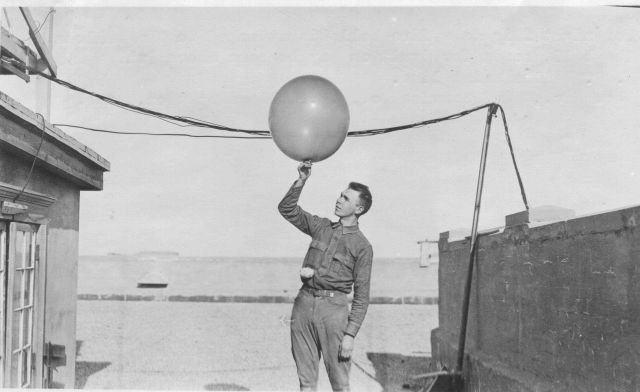 Signal Corps meteorological student Greening launching a weather balloon. Picture