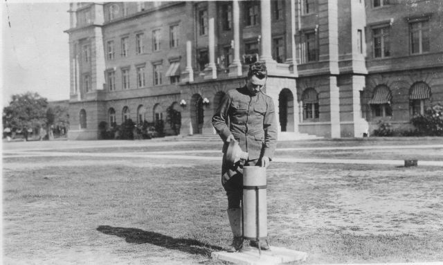 Signal Corps meteorological student measuring precipitation with rain gauge. Picture