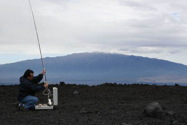 NOAA engineer Paul Fukumura-Sawada captures air near NOAA's Mauna Loa Observatory in Hawaii, using one of many methods to measure carbon dioxide and o Picture