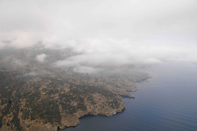 Aerial view of low clouds over the rugged shoreline of Santa Cruz Island. Picture