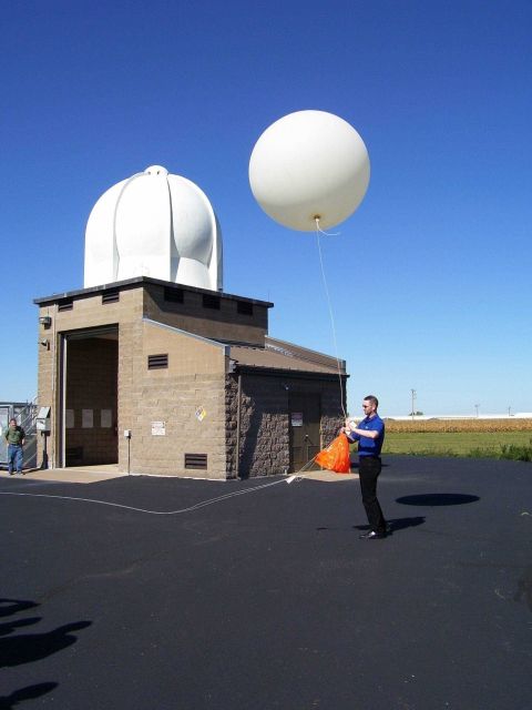 Tom (last name ?) launches a weather balloon during an open house. Picture