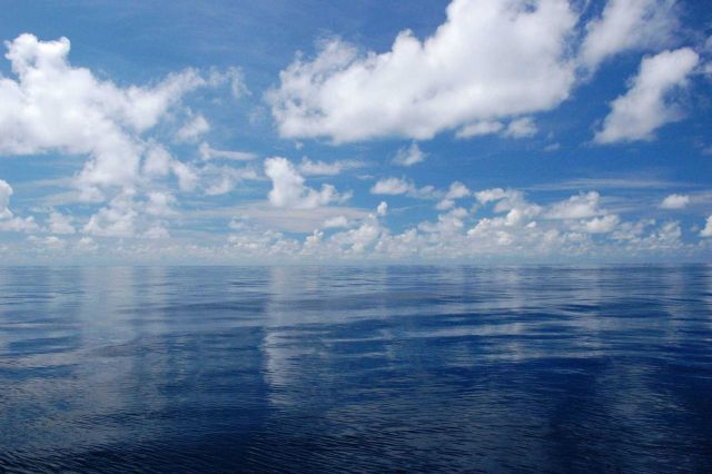 Low lying fair weather cumulus and upper level altocumulus reflecting off a glassy smooth Gulf of Mexico Picture