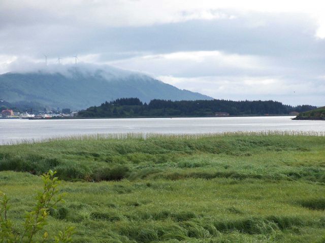 Windmills for power generation on ridge overlooking Kodiak. Picture
