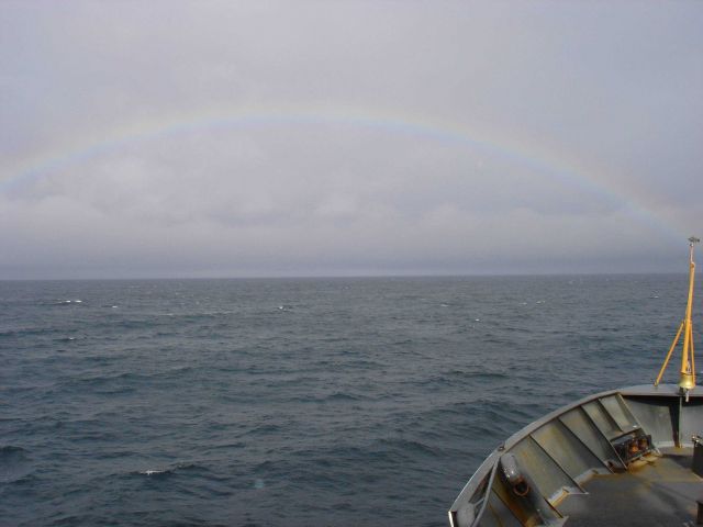 A full rainbow seen on a gray North Pacific day. Picture