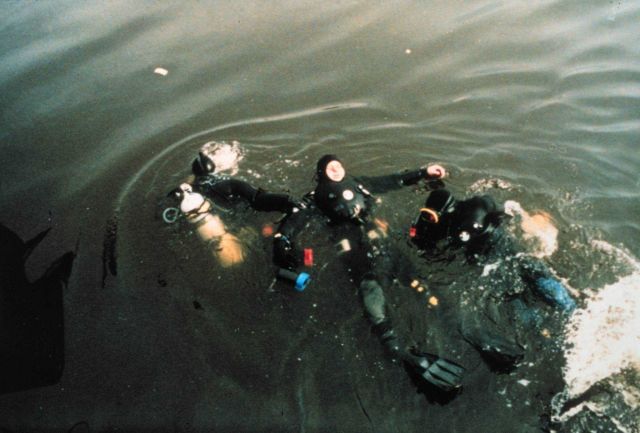 Divers training in handling a disabled dry suit diver. Picture