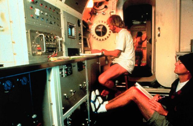 Aquanaut works at computer inside AQUARIUS. Picture