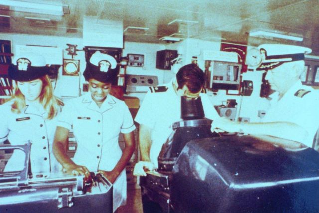 Ensigns Karen O'Donnell and Evelyn Fields, unidentified ensign at radar, and Commander Ronald Buffington on the bridge of the NOAA Ship MT MITCHELL. Picture