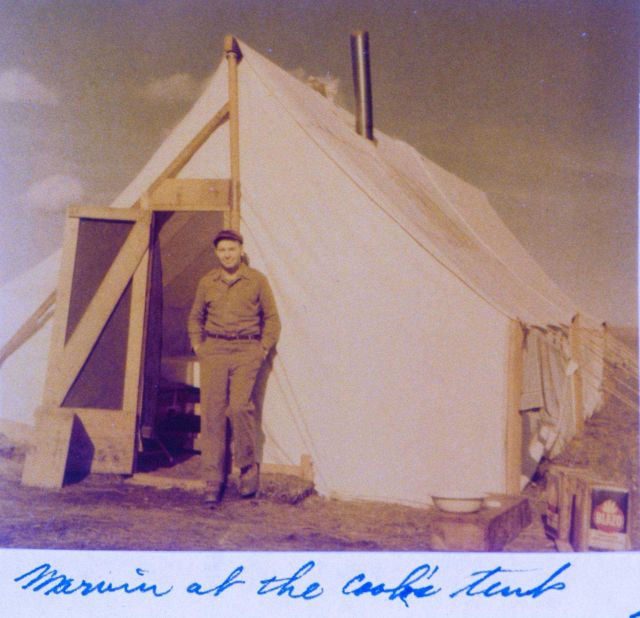 Lieutenant Commander Marvin Paulson at the cook's tent at a triangulation base camp on the Seward Peninsula north of Nome. Picture