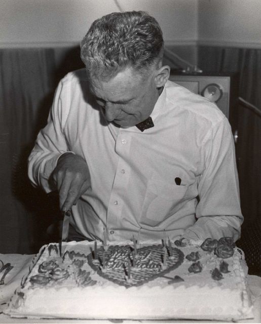 Commander David Whipp cutting birthday cake. Picture