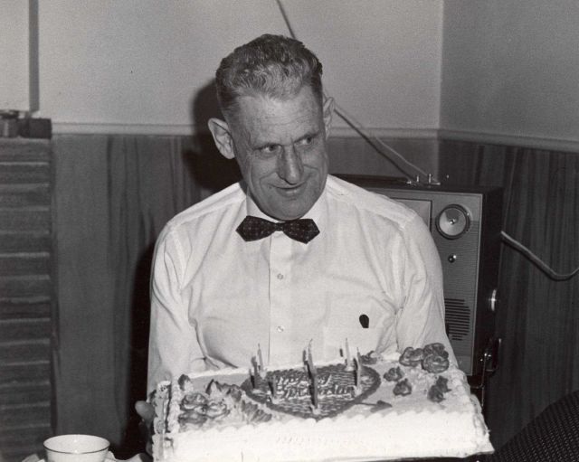 Commander David Whipp holding birthday cake. Picture