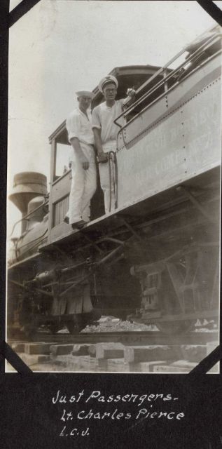 Lieutenant Charles Pierce and Ensign Leonard Johnson as passengers on a logging train in British Northwest Borneo during fueling stop in Sandakan. Picture