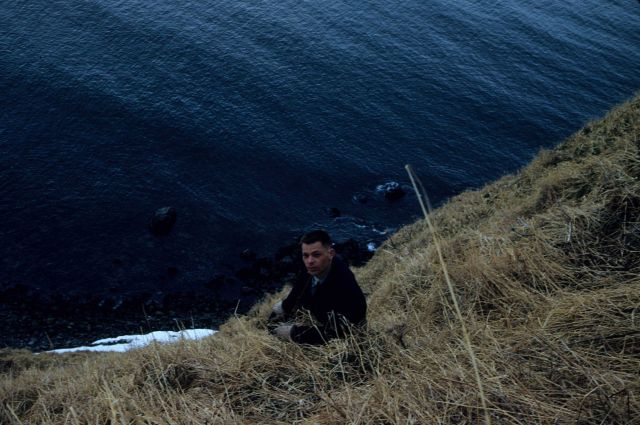Third Assistant Engineer Tom Garten exploring Ragged Point off the Coast and Geodetic Survey Ship PATHFINDER. Picture