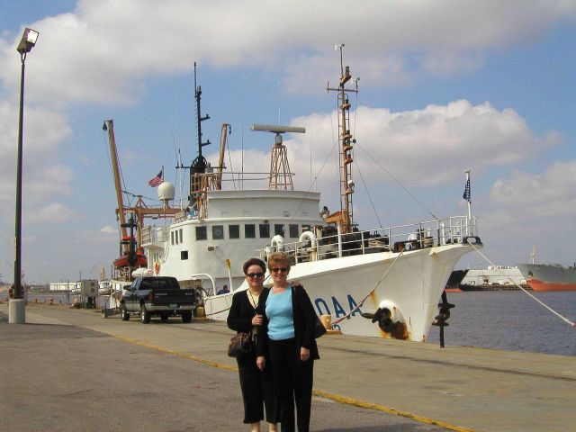 NOAA Central Library head cataloger Anna Fiolek and head of reference Dorothy Anderson in front of NOAA Ship OREGON II at Pascagoula, Mississippi. Picture