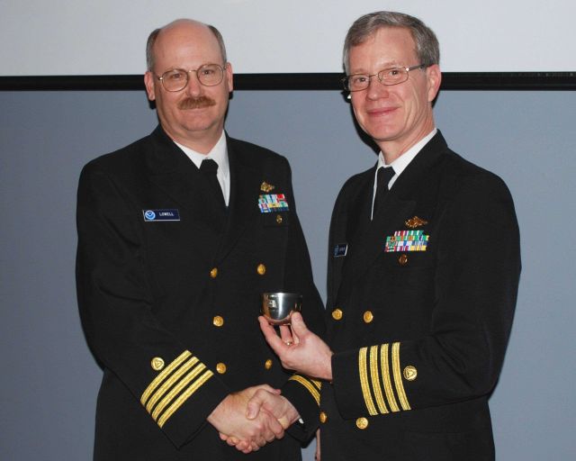 Captain John Lowell on left shaking hands with Captain Steve Barnum, retiring Director of NOAA's Office of Coast Survey Picture