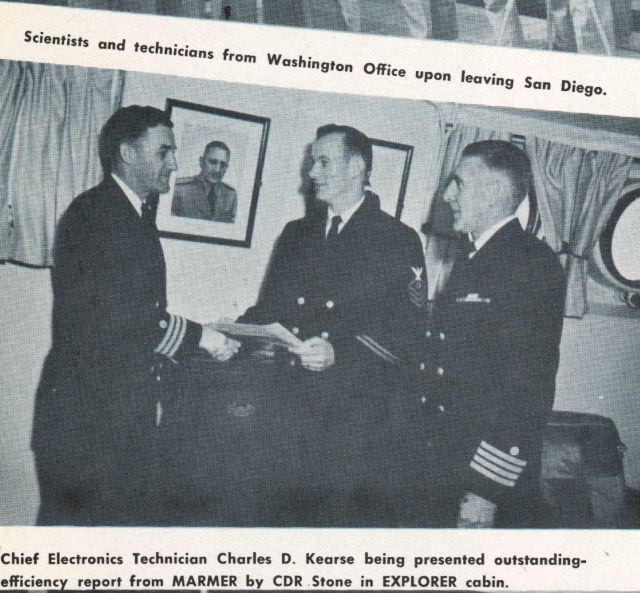 Captain Ray Stone giving Chief Electronics Technician Charles Kearse an award as Captain Emerson Jones looks on Picture