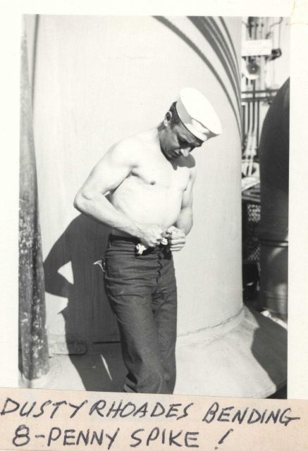 Deck hand Dusty Rhoades bending an 8-penny spike with his bare hands Picture