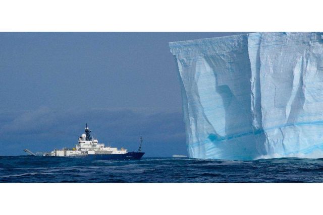 The Scripps Institution of Oceanography R/V Roger Revelle nose-to-nose with an Antarctic iceberg Picture