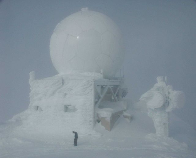 Hunkering down from the wind at the 7,600-foot summit of Mt Picture