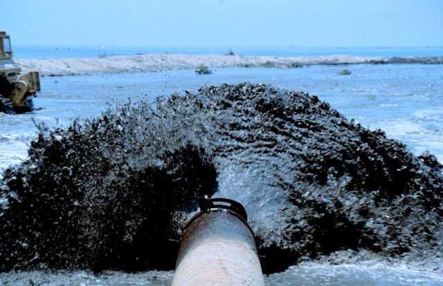 An extreme close up view of sediment being pumped onto the marsh platform. Picture