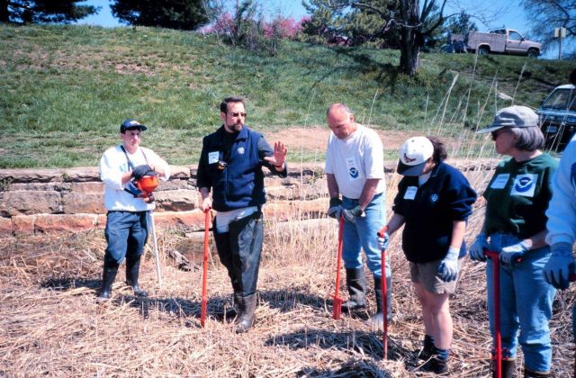 Glenn Page, the Conservation Director for the National Aquarium in Baltimore, instructs volunteers in planting techniques and in using a dibble. Picture