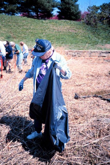 June Gupton, a volunteer, cleans the shoreline at the Ft Picture