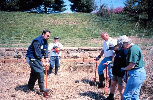 Glenn Page instructs volunteers in planting techniques Picture