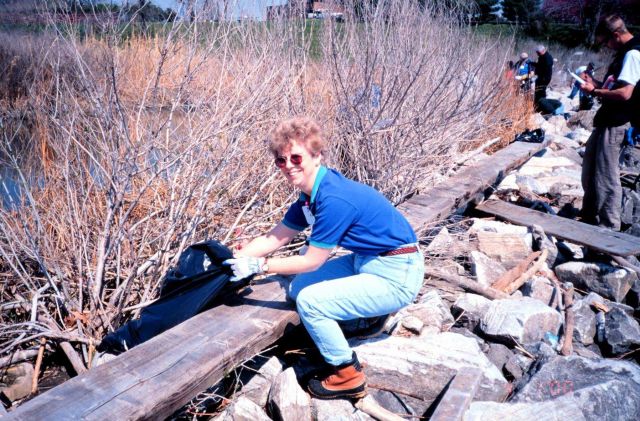 NOAA volunteers clean and remove trash from the rip rap. Picture
