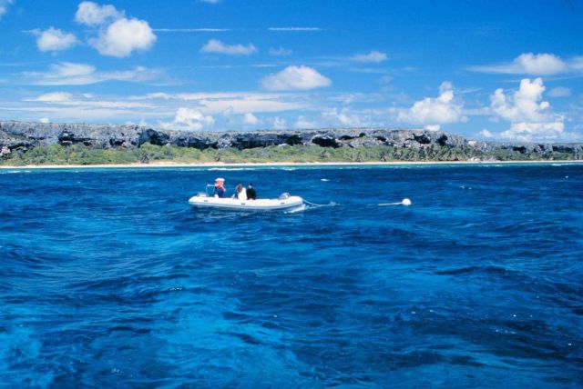 A small tender with divers at the restoration site. Picture