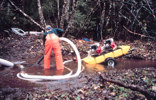 A man works at the dredging process. Picture