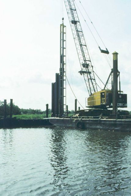 Pile driver pounding sheet metal into location of the self-regulating tide gate SRT. Picture