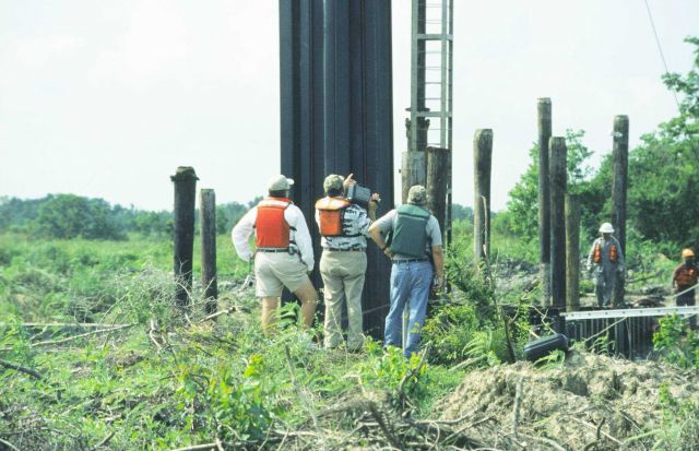NMFS and DNR project managers inspecting installation of sheet metal which will house the SRT. Picture