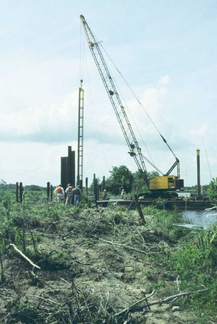 NMFS and DNR project managers inspecting installation of sheet metal which will house the SRT. Picture