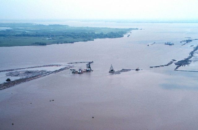 The small dredge in the center of the image, the Katrina, is an hydraulic dredge that pumps sediments into the containment area. Picture