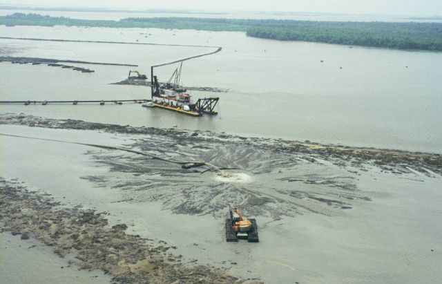 The Captain Berry dredges a containment dike at Big Island. Picture