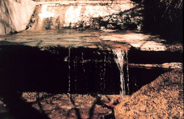 A close-up looking directly upstream at the dam which clearly shows the low flow and large drop that are impediments to fish passage upstream. Picture