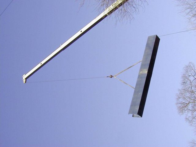 The ladder is suspended in air just before being placed in the dam. Picture