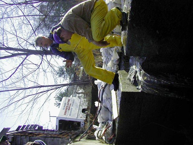 A rest during the work, water is flowing through the cut in the dam. Picture