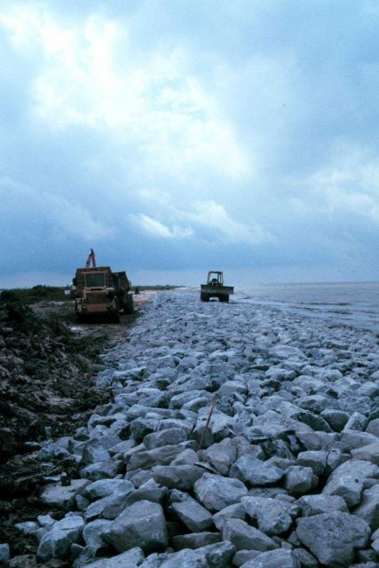 A view of the rock-armored beach with construction equipment. Picture