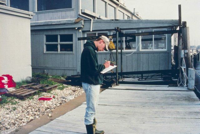 A worker records data about the quahog harvest transferred from Greenwich Bay into the spawner sanctuaries. Picture