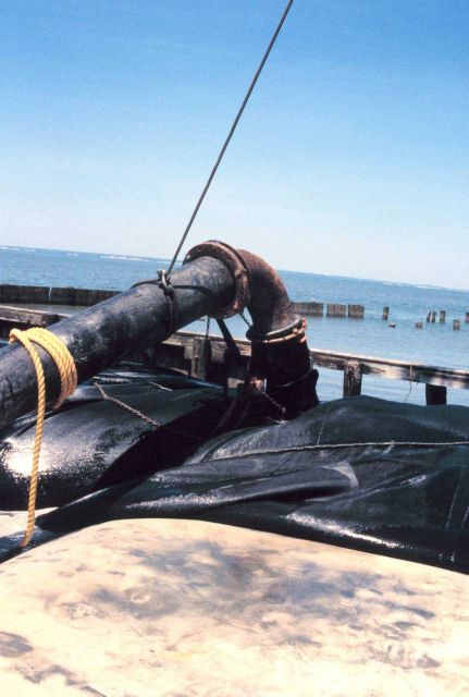 A dredge pipe filling a geotube. Picture